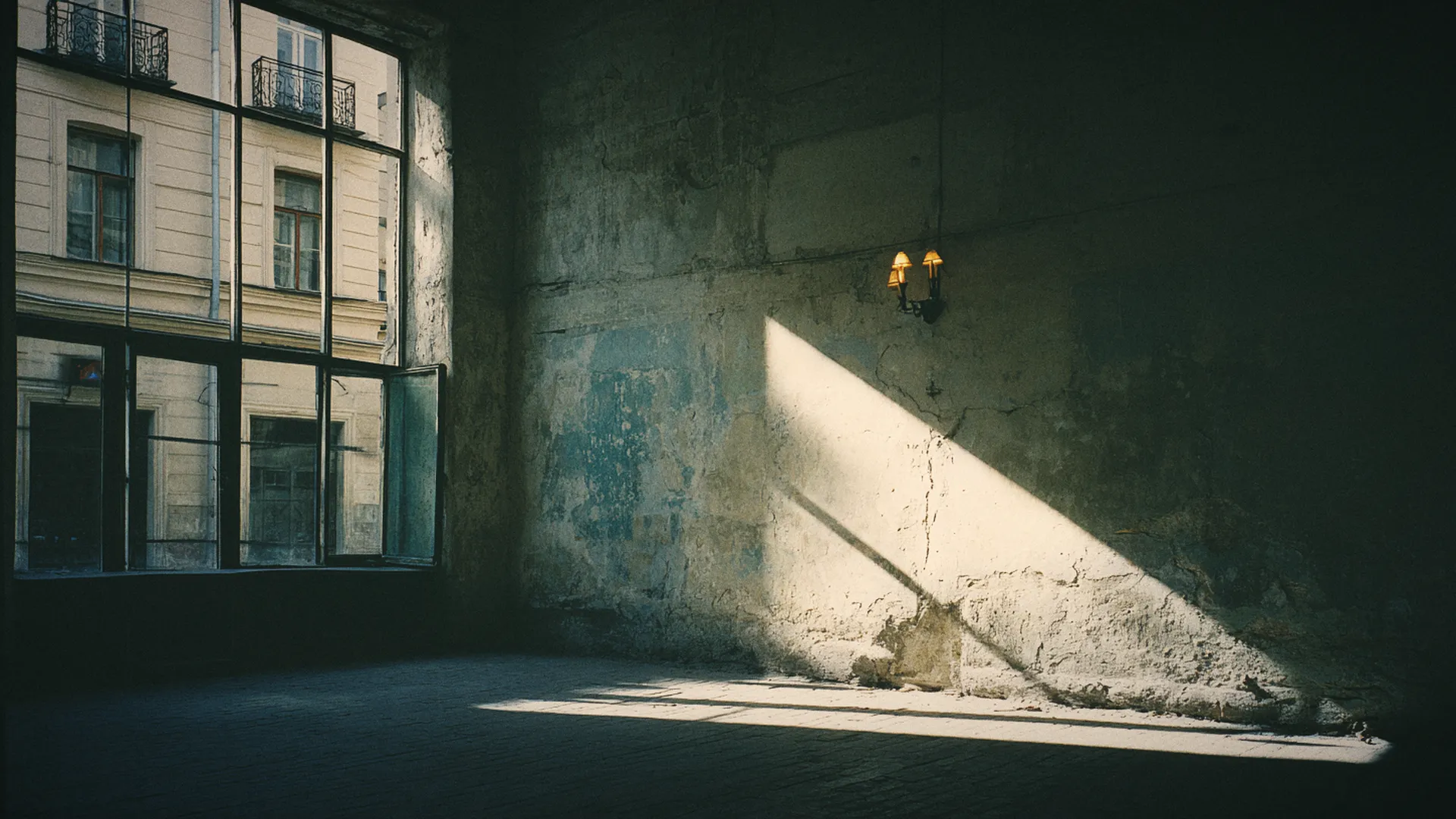 Low winter sun raking across an old plaster wall