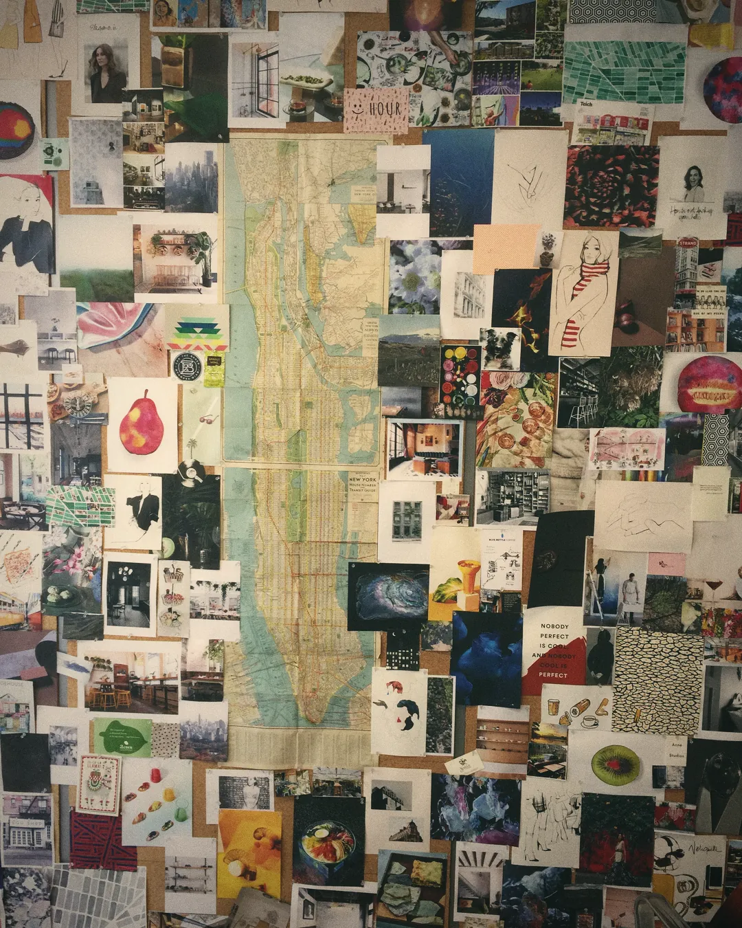 A studio wall covered in pinned images, maps and swatches