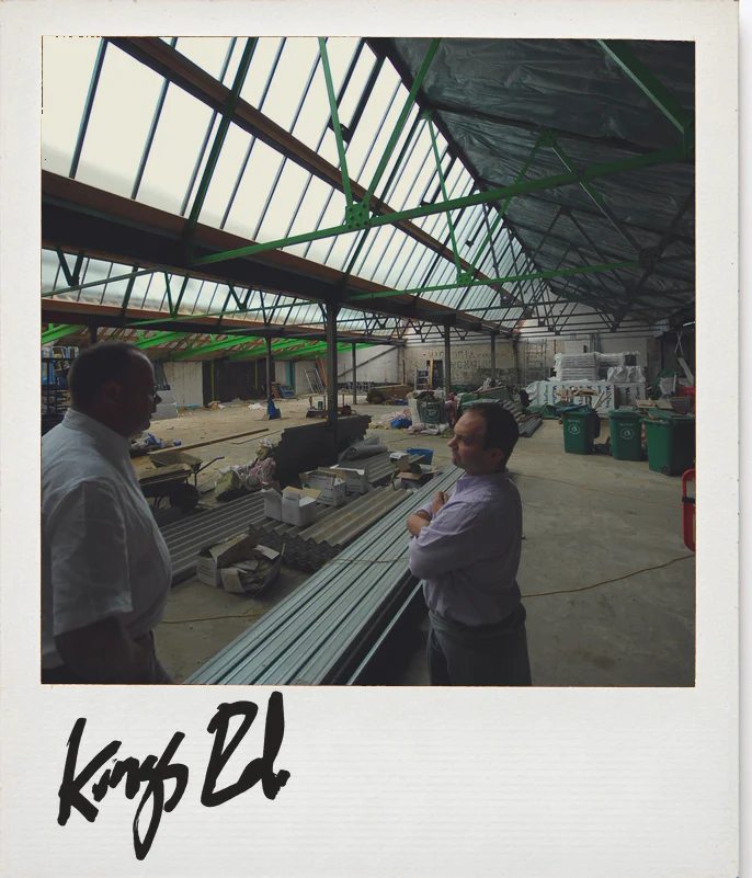 Photo, Anthropologie King’s Road, London, during the build: two people talking under the glazed roof of the hall